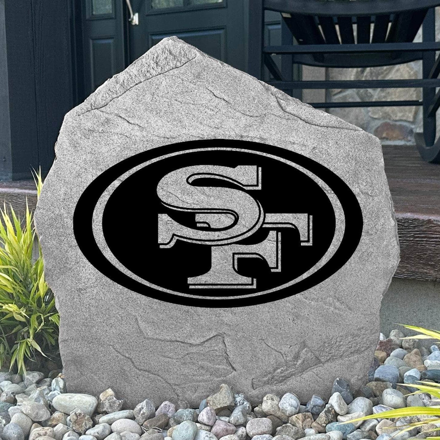 Custom San Francisco 49ers Logo Stone displayed in a landscaped flower bed, showcasing officially licensed team artwork permanently engraved into the stone. This outdoor accent creates a bold focal point for 49ers fans and outdoor living spaces.