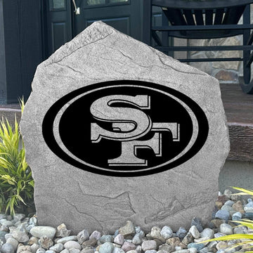 Custom San Francisco 49ers Logo Stone displayed in a landscaped flower bed, showcasing officially licensed team artwork permanently engraved into the stone. This outdoor accent creates a bold focal point for 49ers fans and outdoor living spaces.