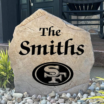 Officially licensed San Francisco 49ers Name Stone featuring a personalized family name and the iconic San Francisco 49ers logo engraved directly into the stone surface. This custom garden stone adds NFL team pride and curb appeal to front yards, patios, gardens, and entryways.
