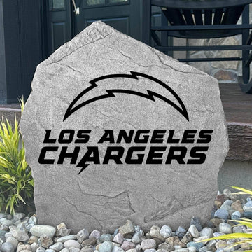 Custom Los Angeles Chargers Logo Stone displayed in a landscaped flower bed, showcasing officially licensed team artwork permanently engraved into the stone. This outdoor accent creates a bold focal point for Chargers fans and outdoor living spaces.