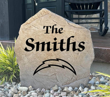 Officially licensed Los Angeles Chargers Name Stone featuring a personalized family name and the iconic Los Angeles Chargers logo engraved directly into the stone surface. This custom garden stone adds NFL team pride and curb appeal to front yards, patios, gardens, and entryways.
