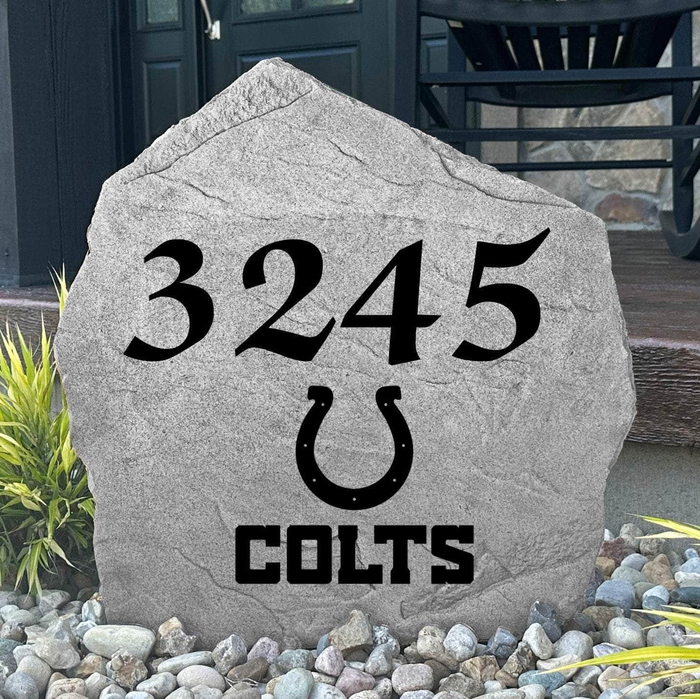 Custom Indianapolis Colts Address Stone displayed in a landscaped flower bed with personalized house numbers and officially licensed team artwork. This engraved address marker creates a striking focal point for Colts fans and outdoor living spaces.