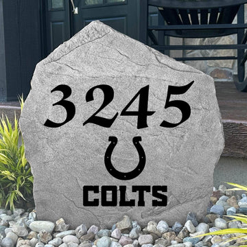 Custom Indianapolis Colts Address Stone displayed in a landscaped flower bed with personalized house numbers and officially licensed team artwork. This engraved address marker creates a striking focal point for Colts fans and outdoor living spaces.
