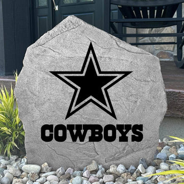 Custom Dallas Cowboys Logo Stone displayed in a landscaped flower bed, showcasing officially licensed team artwork permanently engraved into the stone. This outdoor accent creates a bold focal point for Cowboys fans and outdoor living spaces.