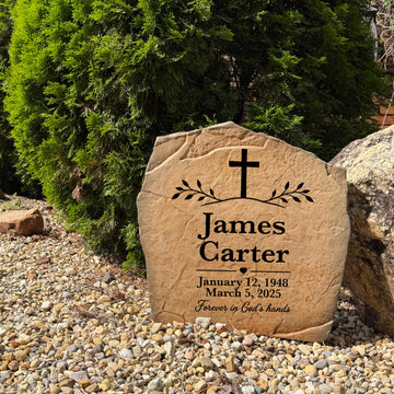 Personalized memorial stone with elegant cross engraving displayed in a garden, cemetery, or remembrance space