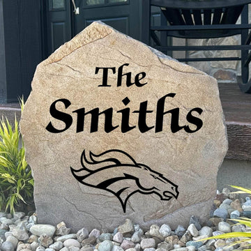 Officially licensed Denver Broncos Name Stone featuring a personalized family name and the iconic Denver Broncos logo engraved directly into the stone surface. This custom garden stone adds NFL team pride and curb appeal to front yards, patios, gardens, and entryways.
