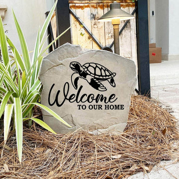 Engraved Welcome Sea Turtle Stone nestled among colorful flowers and natural greenery, bringing beach-inspired beauty and timeless style to gardens, patios, and home entrances.