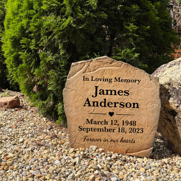 Engraved Forever In Our Hearts remembrance stone displayed in a beautiful garden landscape