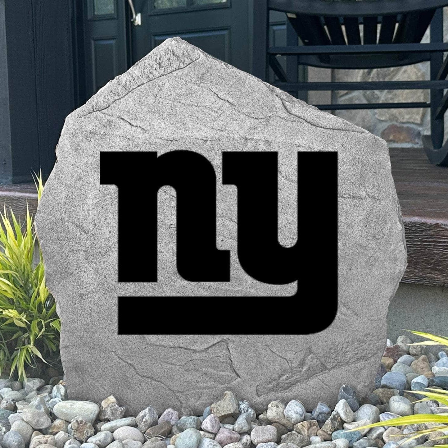 Custom New York Giants Logo Stone displayed in a landscaped flower bed, showcasing officially licensed team artwork permanently engraved into the stone. This outdoor accent creates a bold focal point for Giants fans and outdoor living spaces.