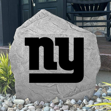 Custom New York Giants Logo Stone displayed in a landscaped flower bed, showcasing officially licensed team artwork permanently engraved into the stone. This outdoor accent creates a bold focal point for Giants fans and outdoor living spaces.
