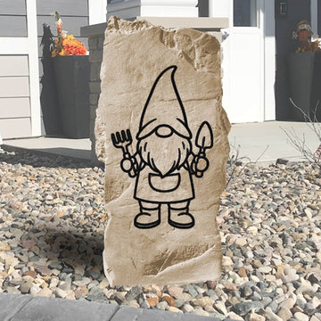 Nestled among blooming flowers and fresh mulch, the Vertical Gnome Stone brings cheerful personality to the garden with its engraved gnome design and tall profile. Perfect for adding a touch of whimsy, this charming accent creates a fun and inviting atmosphere along walkways, patios, or entryways.