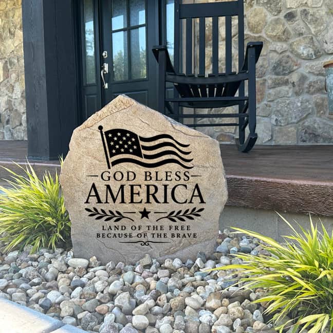 Premium God Bless America garden stone featuring an engraved American flag and inspiring patriotic message. This outdoor accent creates a welcoming focal point while honoring the values of freedom and faith.