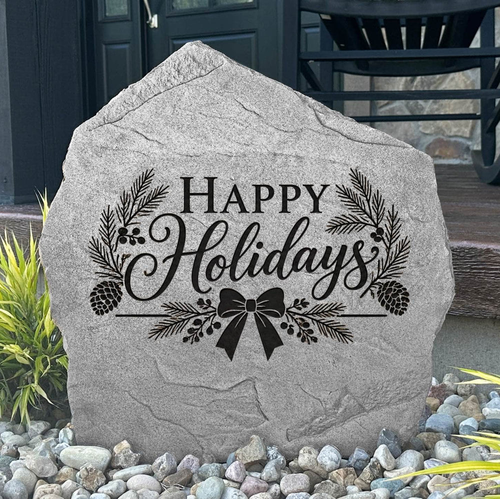 Greystone Happy Holidays Stone with pinecone and ribbon bow engraving beside a black front door
