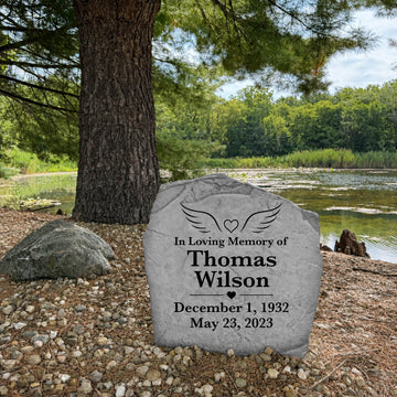 Personalized remembrance stone with a heart and angel wings engraved directly into durable stone for a timeless memorial.