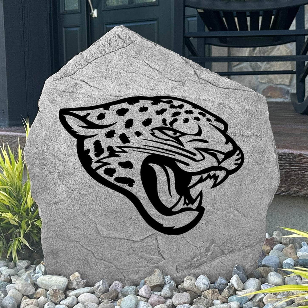 Custom Jacksonville Jaguars Logo Stone displayed in a landscaped flower bed, showcasing officially licensed team artwork permanently engraved into the stone. This outdoor accent creates a bold focal point for Jaguars fans and outdoor living spaces.