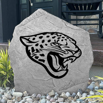 Custom Jacksonville Jaguars Logo Stone displayed in a landscaped flower bed, showcasing officially licensed team artwork permanently engraved into the stone. This outdoor accent creates a bold focal point for Jaguars fans and outdoor living spaces.