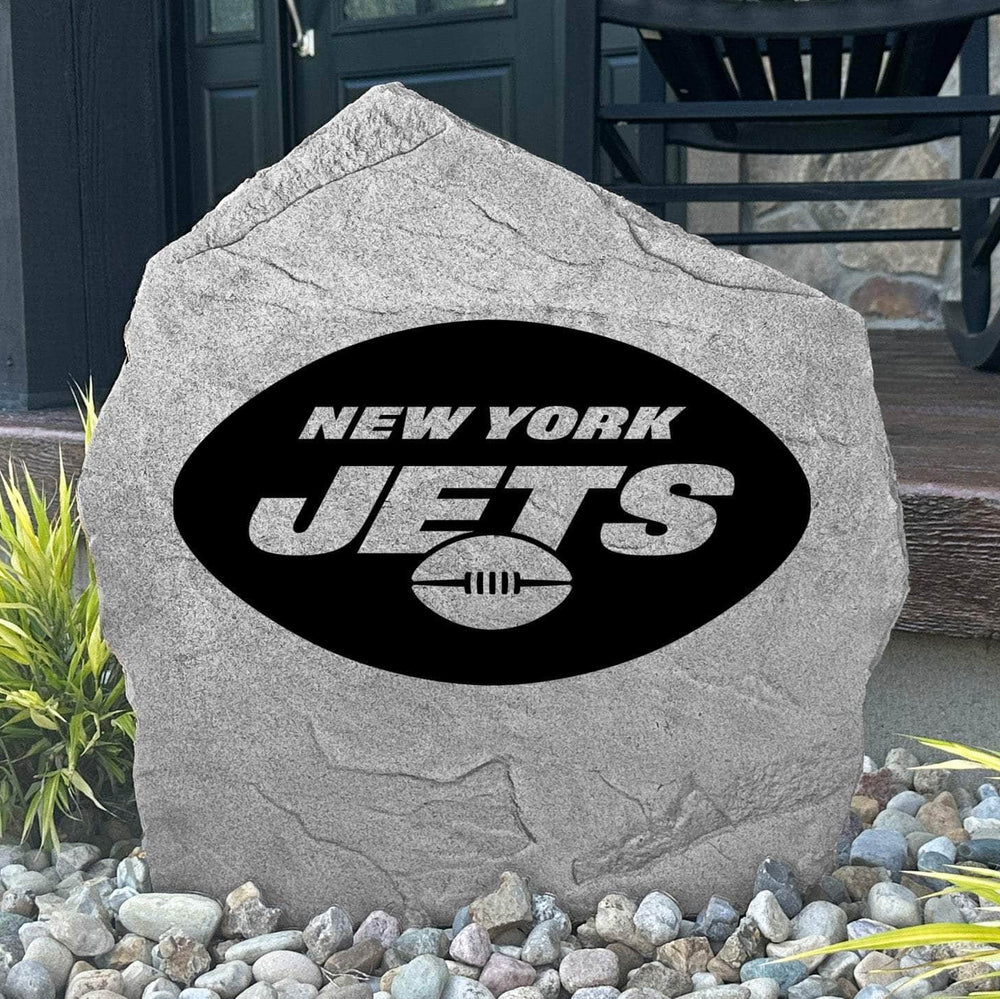 Custom New York Jets Logo Stone displayed in a landscaped flower bed, showcasing officially licensed team artwork permanently engraved into the stone. This outdoor accent creates a bold focal point for Jets fans and outdoor living spaces.