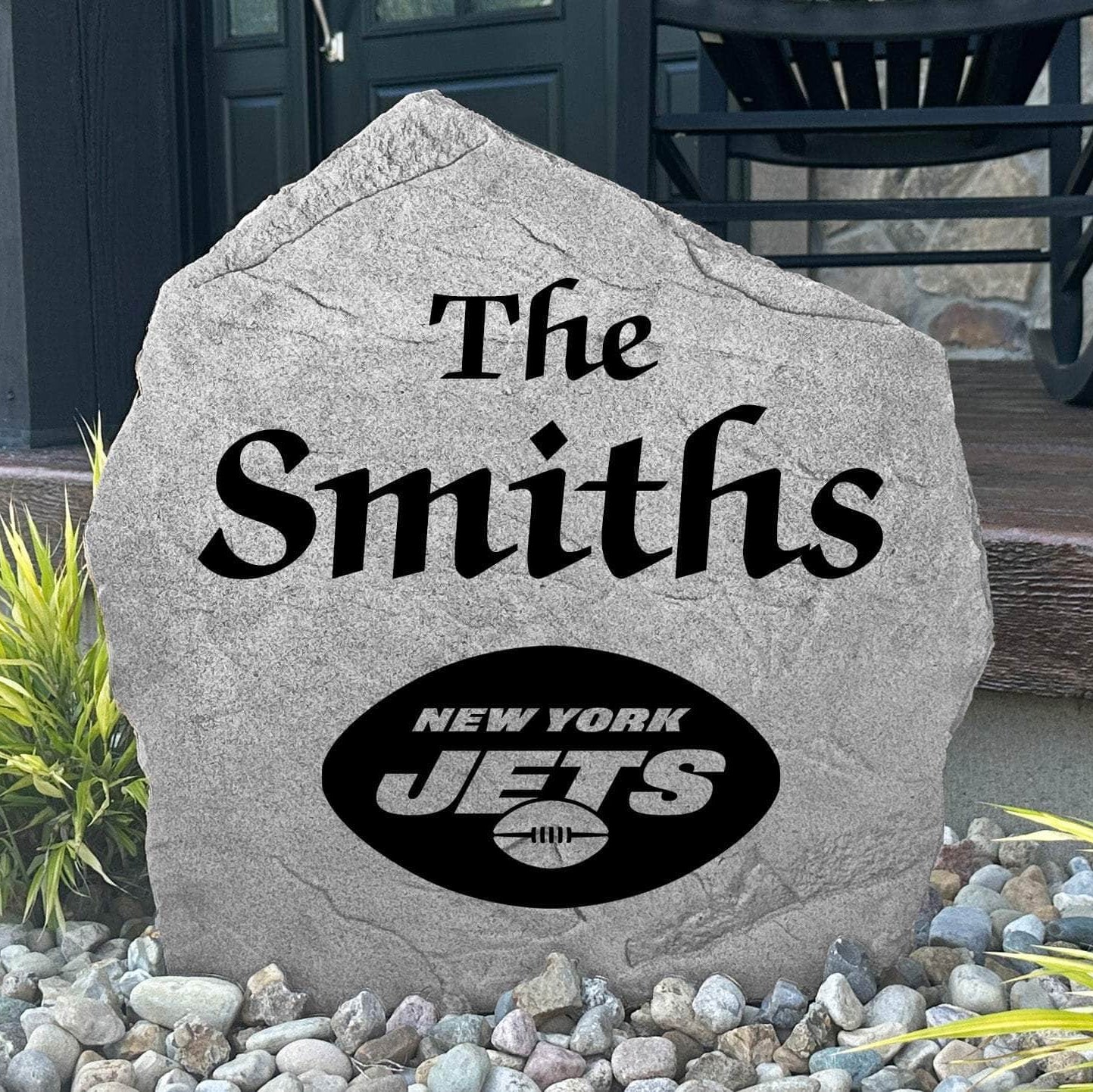 Custom New York Jets Name Stone displayed in a landscaped flower bed, showcasing personalized family lettering and officially licensed team artwork. This decorative outdoor stone creates a striking focal point for Jets fans and outdoor living spaces.