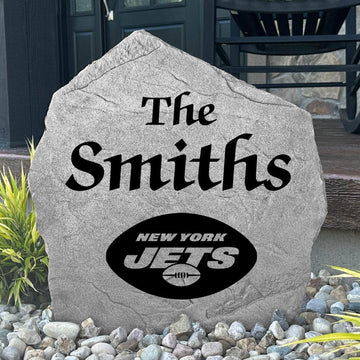 Custom New York Jets Name Stone displayed in a landscaped flower bed, showcasing personalized family lettering and officially licensed team artwork. This decorative outdoor stone creates a striking focal point for Jets fans and outdoor living spaces.