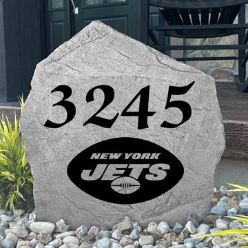 Custom New York Jets Address Stone displayed in a landscaped flower bed with personalized house numbers and officially licensed team artwork. This engraved address marker creates a striking focal point for Jets fans and outdoor living spaces.