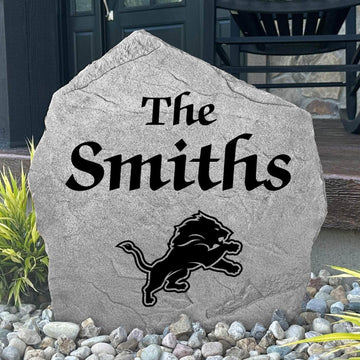 Officially licensed Detroit Lions Name Stone featuring a personalized family name and the iconic Detroit Lions logo engraved directly into the stone surface. This custom garden stone adds NFL team pride and curb appeal to front yards, patios, gardens, and entryways.