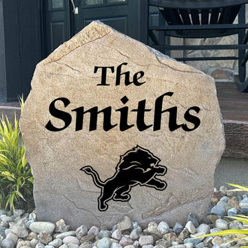 Officially licensed Detroit Lions Name Stone featuring a personalized family name and the iconic Detroit Lions logo engraved directly into the stone surface. This custom garden stone adds NFL team pride and curb appeal to front yards, patios, gardens, and entryways.