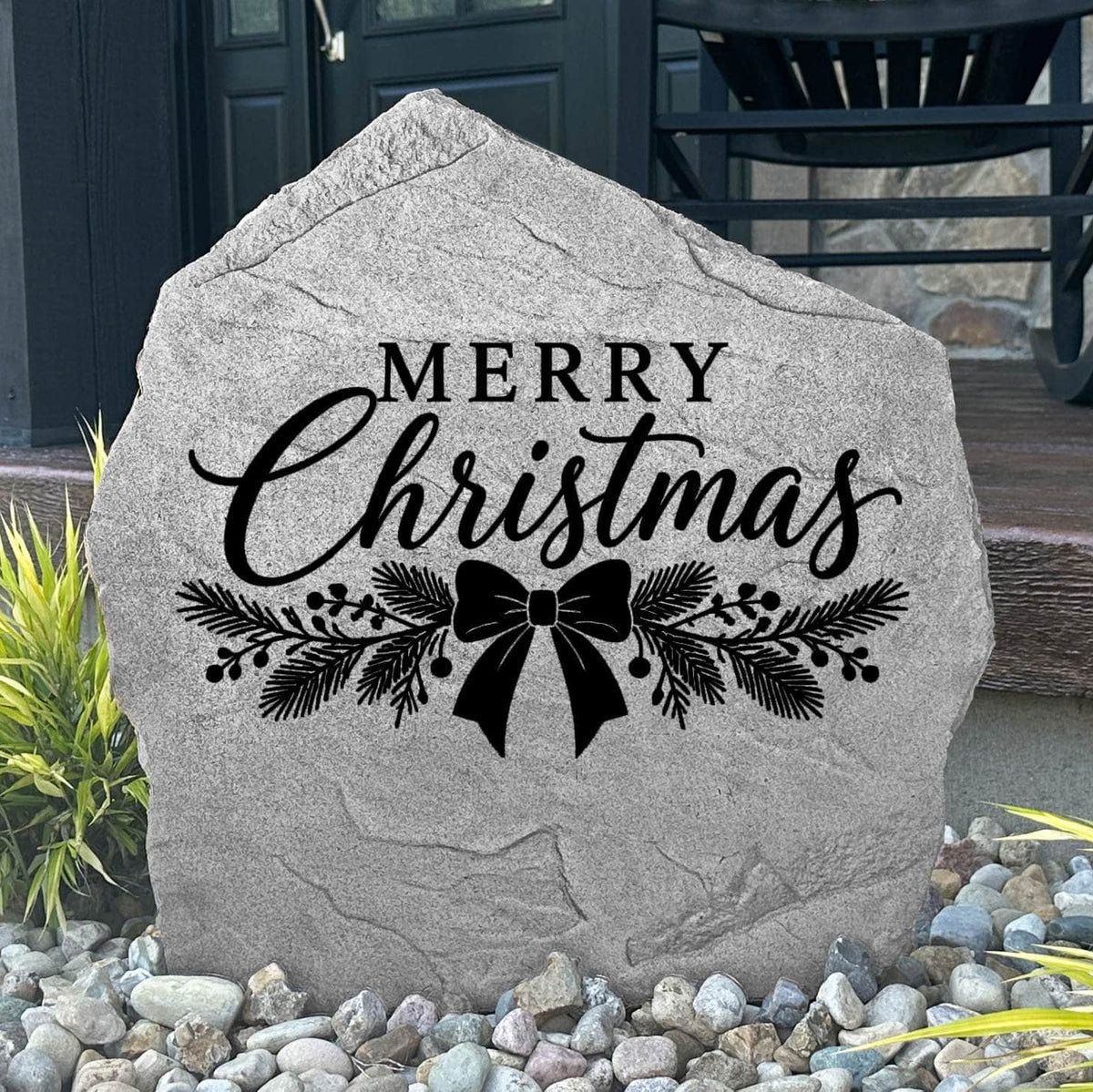 Greystone Merry Christmas Stone with pine and ribbon bow engraving beside a black front door