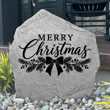 Greystone Merry Christmas Stone with pine and ribbon bow engraving beside a black front door