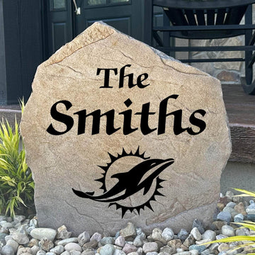Officially licensed Miami Dolphins Name Stone featuring a personalized family name and the iconic Miami Dolphins logo engraved directly into the stone surface. This custom garden stone adds NFL team pride and curb appeal to front yards, patios, gardens, and entryways.