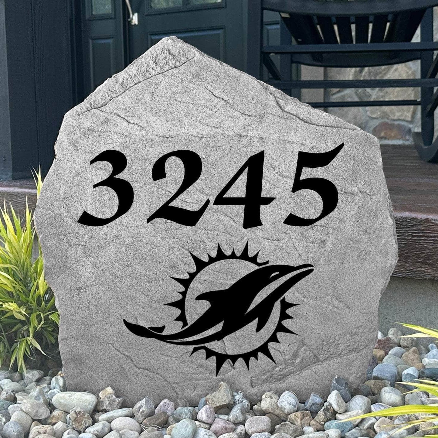 Custom Miami Dolphins Address Stone displayed in a landscaped flower bed with personalized house numbers and officially licensed team artwork. This engraved address marker creates a striking focal point for Dolphins fans and outdoor living spaces.