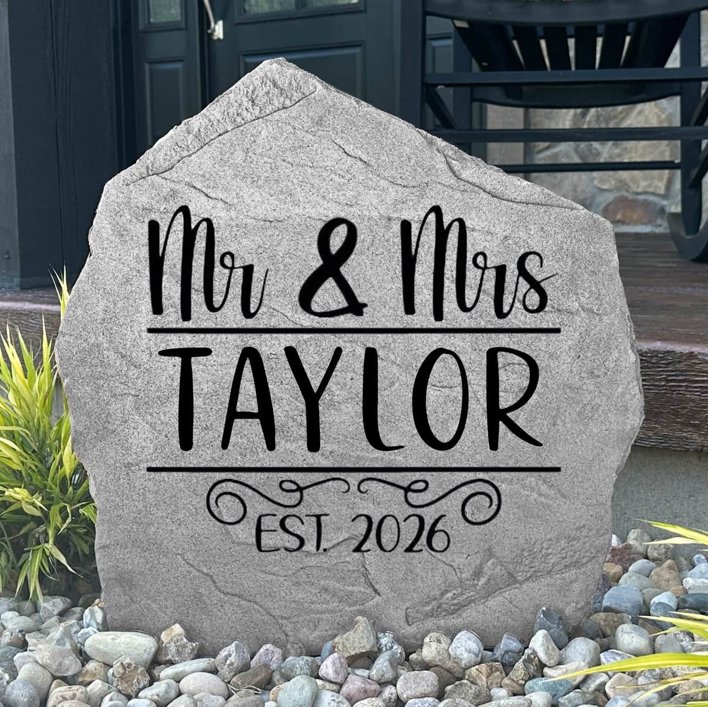 Custom Mr. & Mrs. Name Stone displayed in a landscaped flower bed, showcasing personalized names and wedding-inspired engraving. This decorative garden stone creates a beautiful focal point for newlyweds and family homes.