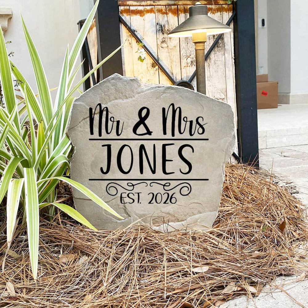 Decorative Mr. & Mrs. Name Stone featuring custom family names permanently engraved into the stone surface. Perfect as a wedding gift or housewarming gift, this personalized stone enhances entryways and landscape beds.