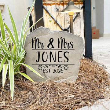 Decorative Mr. & Mrs. Name Stone featuring custom family names permanently engraved into the stone surface. Perfect as a wedding gift or housewarming gift, this personalized stone enhances entryways and landscape beds.