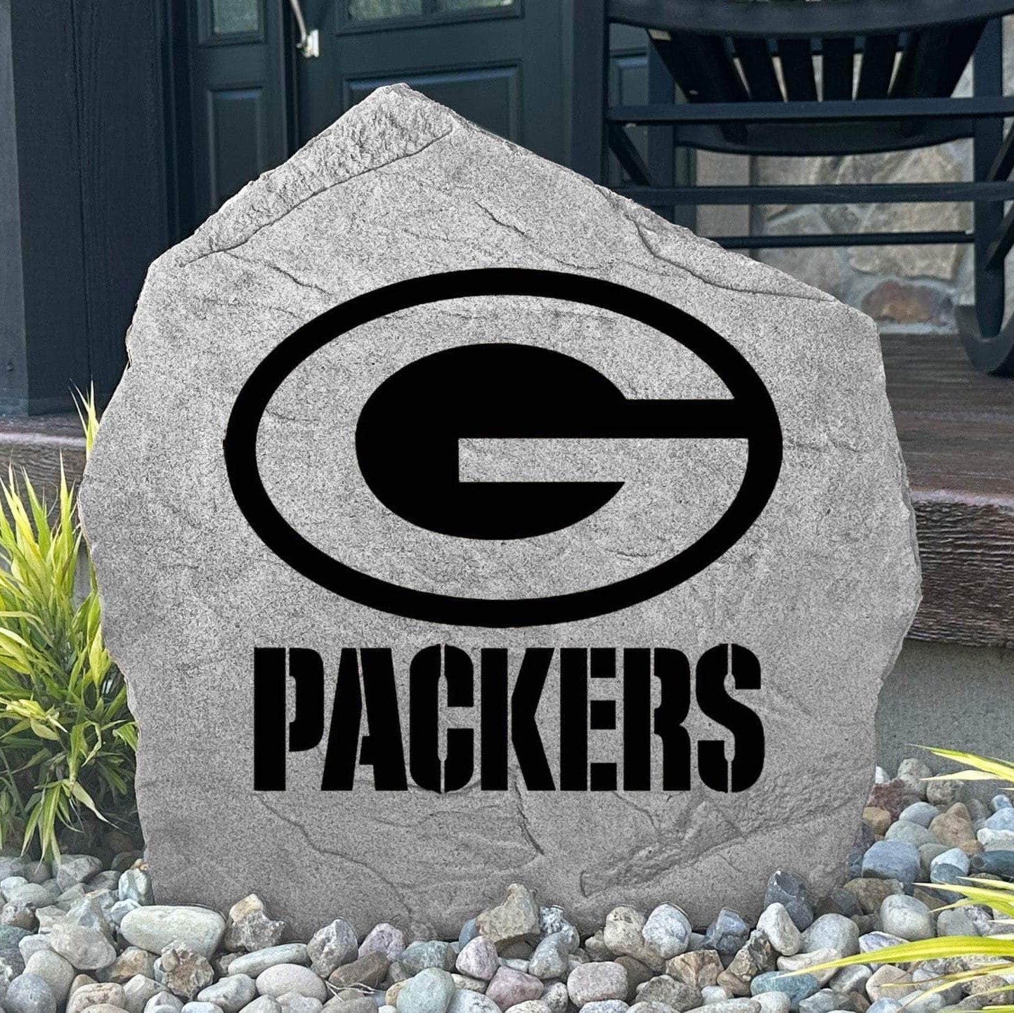 Custom Green Bay Packers Logo Stone displayed in a landscaped flower bed, showcasing officially licensed team artwork permanently engraved into the stone. This outdoor accent creates a bold focal point for Packers fans and outdoor living spaces.