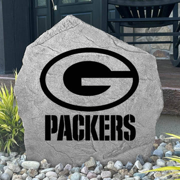 Custom Green Bay Packers Logo Stone displayed in a landscaped flower bed, showcasing officially licensed team artwork permanently engraved into the stone. This outdoor accent creates a bold focal point for Packers fans and outdoor living spaces.
