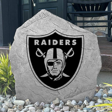 Custom Las Vegas Raiders Logo Stone displayed in a landscaped flower bed, showcasing officially licensed team artwork permanently engraved into the stone. This outdoor accent creates a bold focal point for Raiders fans and outdoor living spaces.