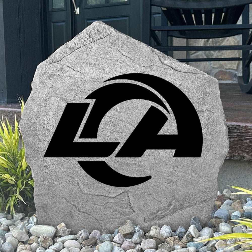 Custom Los Angeles Rams Logo Stone displayed in a landscaped flower bed, showcasing officially licensed team artwork permanently engraved into the stone. This outdoor accent creates a bold focal point for Rams fans and outdoor living spaces.