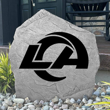 Custom Los Angeles Rams Logo Stone displayed in a landscaped flower bed, showcasing officially licensed team artwork permanently engraved into the stone. This outdoor accent creates a bold focal point for Rams fans and outdoor living spaces.