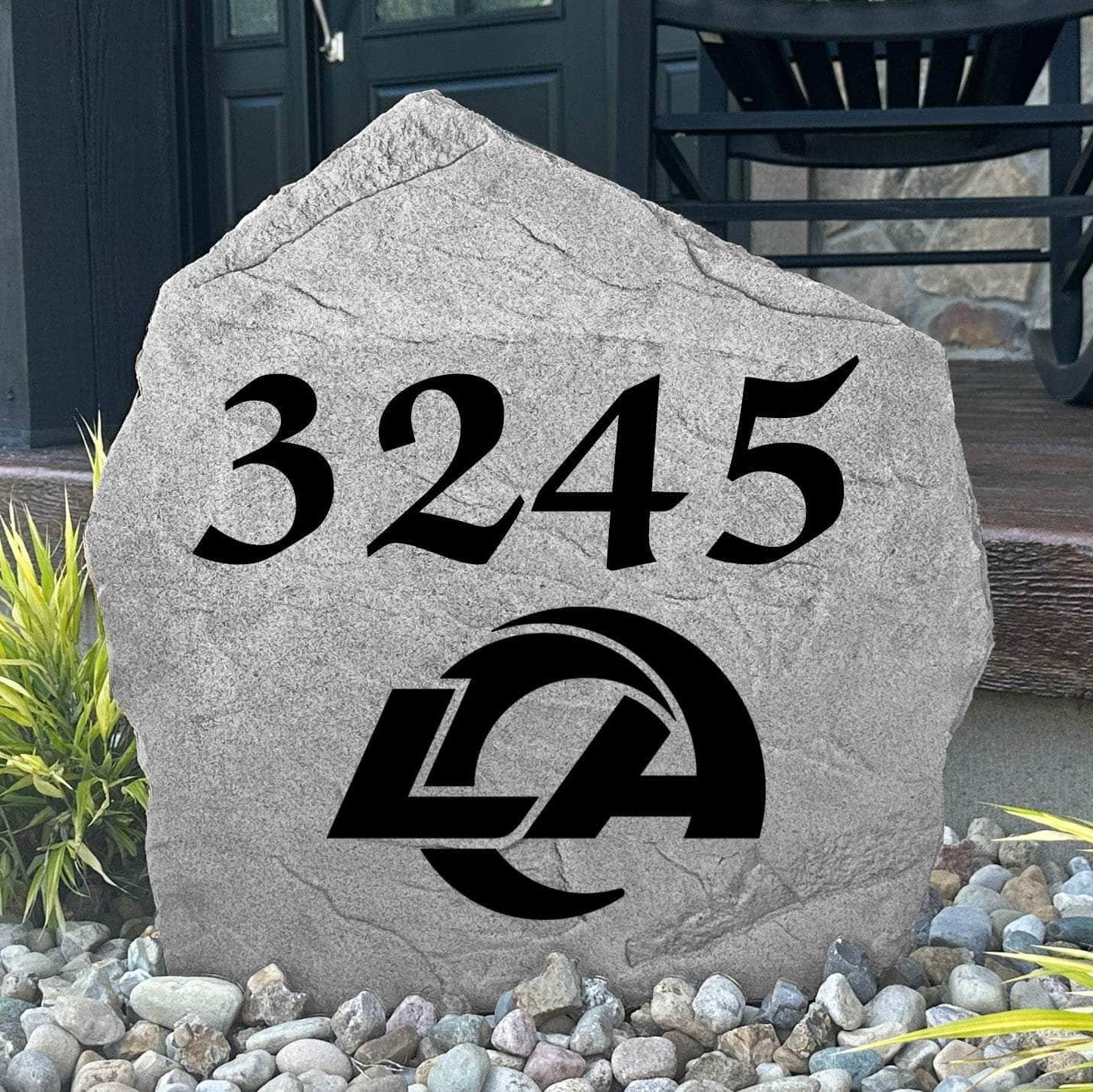Custom Los Angeles Rams Address Stone displayed in a landscaped flower bed with personalized house numbers and officially licensed team artwork. This engraved address marker creates a striking focal point for Rams fans and outdoor living spaces.