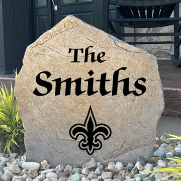 Officially licensed New Orleans Saints Name Stone featuring a personalized family name and the iconic New Orleans Saints logo engraved directly into the stone surface. This custom garden stone adds NFL team pride and curb appeal to front yards, patios, gardens, and entryways.