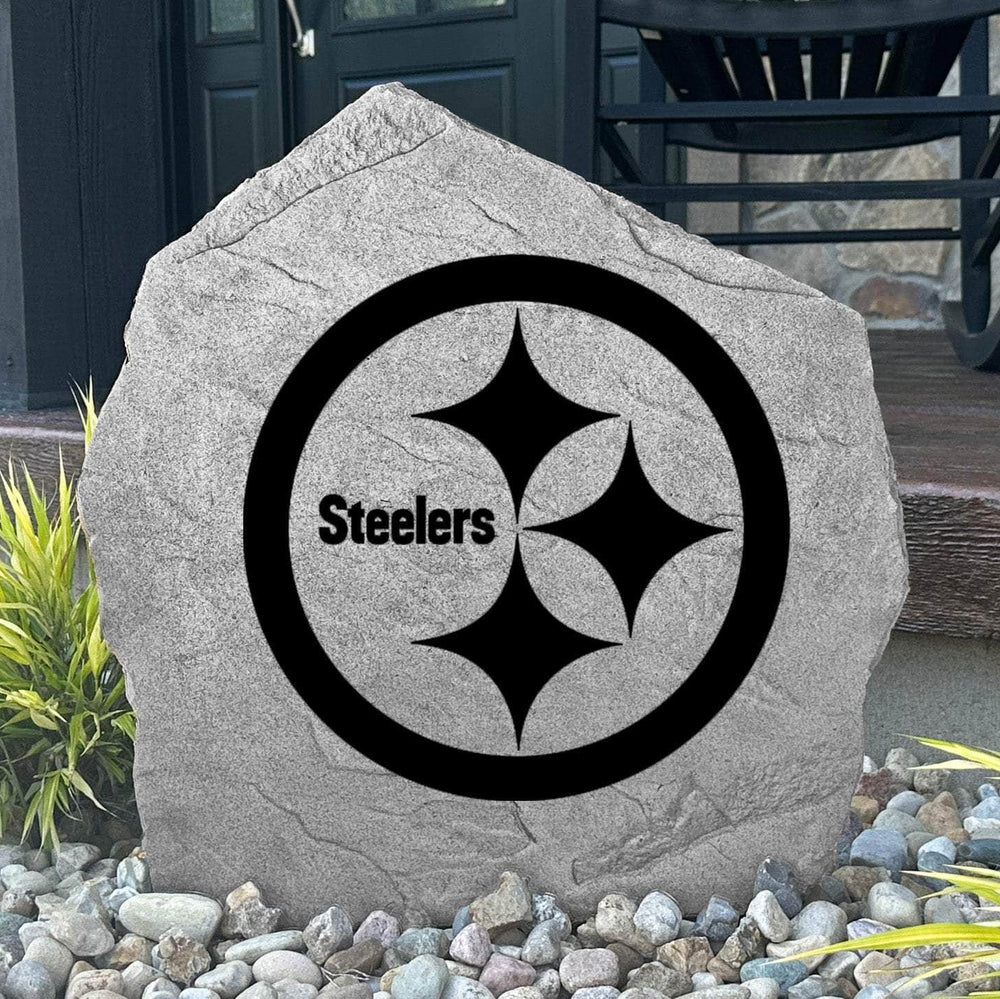 Custom Pittsburgh Steelers Logo Stone displayed in a landscaped flower bed, showcasing officially licensed team artwork permanently engraved into the stone. This outdoor accent creates a bold focal point for Steelers fans and outdoor living spaces.