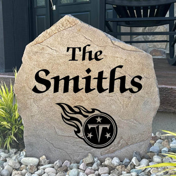 Officially licensed Tennessee Titans Name Stone featuring a personalized family name and the iconic Tennessee Titans logo engraved directly into the stone surface. This custom garden stone adds NFL team pride and curb appeal to front yards, patios, gardens, and entryways.