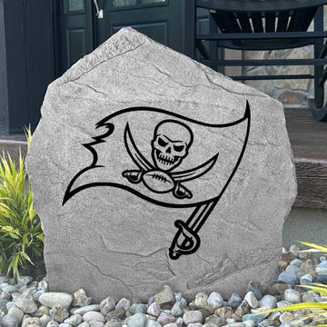 Custom Tampa Bay Buccaneers Logo Stone displayed in a landscaped flower bed, showcasing officially licensed team artwork permanently engraved into the stone. This outdoor accent creates a bold focal point for Buccaneers fans and outdoor living spaces.