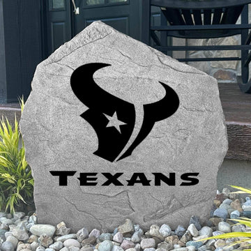 Custom Houston Texans Logo Stone displayed in a landscaped flower bed, showcasing officially licensed team artwork permanently engraved into the stone. This outdoor accent creates a bold focal point for Texans fans and outdoor living spaces.