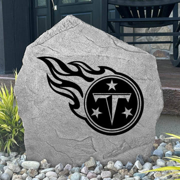 Custom Tennessee Titans Logo Stone displayed in a landscaped flower bed, showcasing officially licensed team artwork permanently engraved into the stone. This outdoor accent creates a bold focal point for Titans fans and outdoor living spaces.