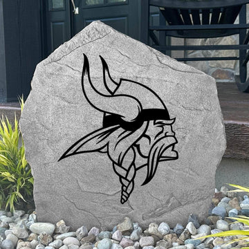 Custom Minnesota Vikings Logo Stone displayed in a landscaped flower bed, showcasing officially licensed team artwork permanently engraved into the stone. This outdoor accent creates a bold focal point for Vikings fans and outdoor living spaces.