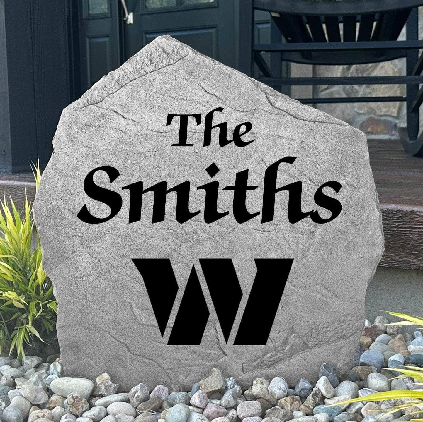 Custom Washington Commanders Name Stone displayed in a landscaped flower bed, showcasing personalized family lettering and officially licensed team artwork. This decorative outdoor stone creates a striking focal point for football fans and outdoor living spaces.