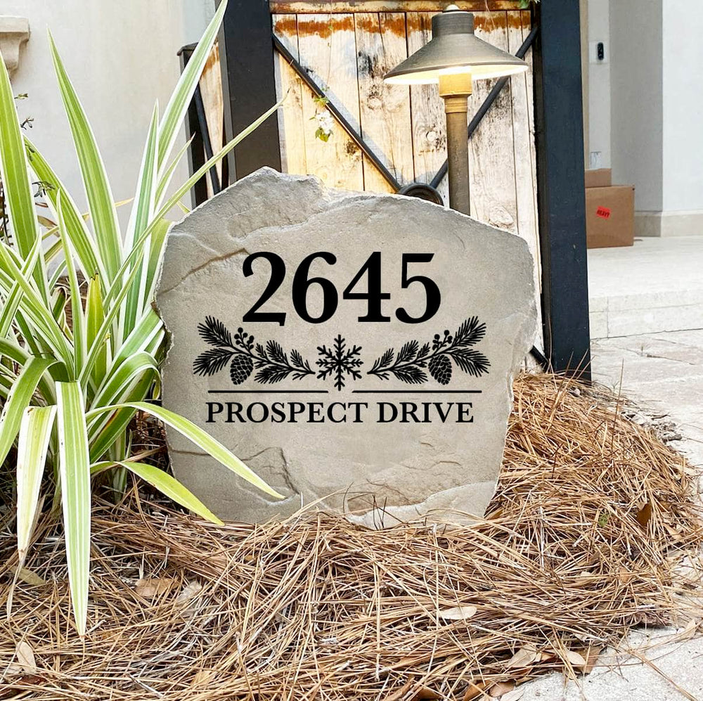 Winter Address Stone engraved 2645 Prospect Drive on pine straw next to a rustic gate and landscape light