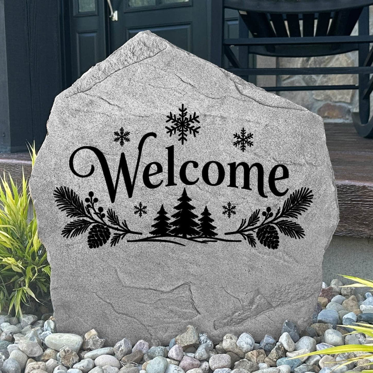 Greystone Winter Welcome Stone with evergreen and snowflake engraving beside a black front door