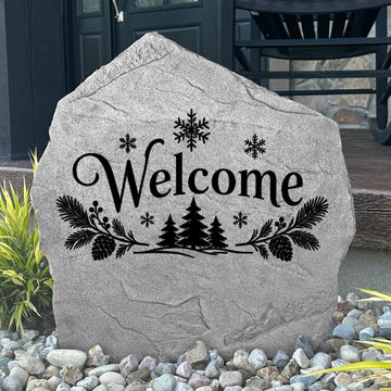 Greystone Winter Welcome Stone with evergreen and snowflake engraving beside a black front door